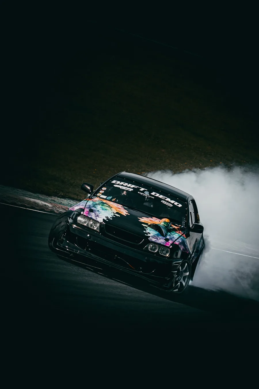 Drift car creating tyre smoke at night